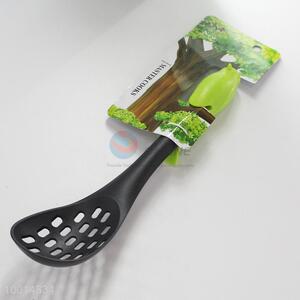 Small kitchen slotted spoon with bird-shaped handle